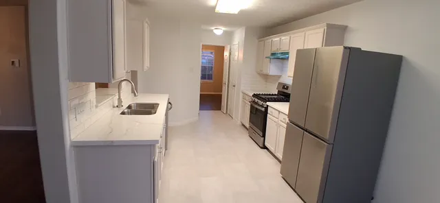 a kitchen with stainless steel appliances a refrigerator and a sink