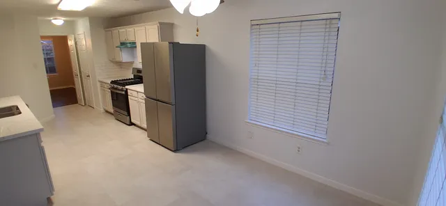 a kitchen with stainless steel appliances a refrigerator and a stove