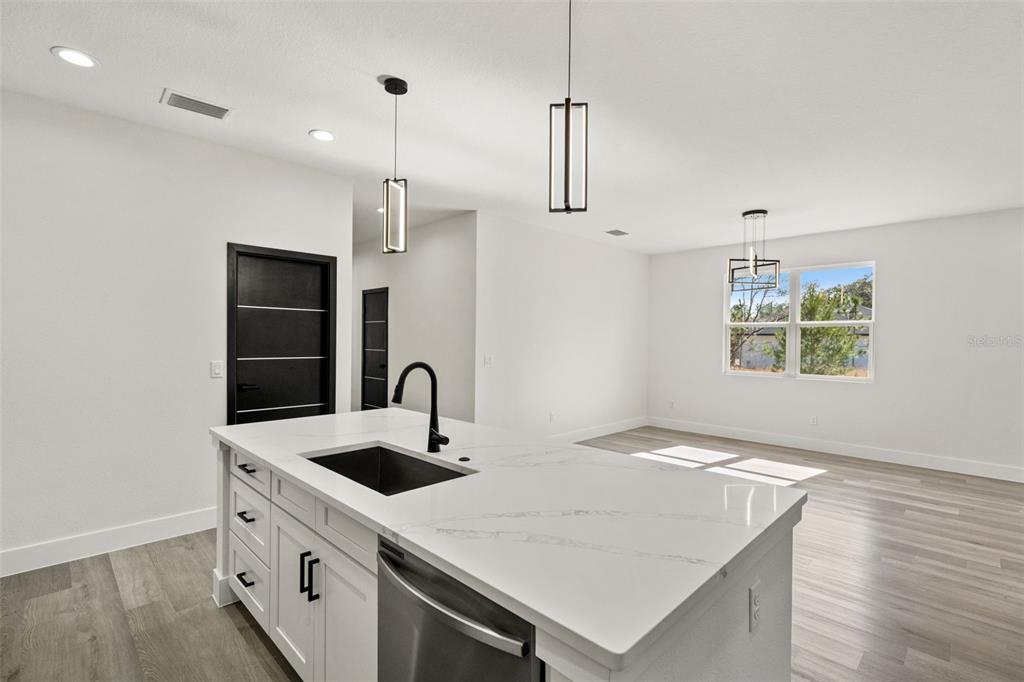 2956 West Higgins Place Dunnellon, FL 34433 - Photo 15 of 52 a kitchen with stainless steel appliances granite countertop a sink a oven a refrigerator and white cabinets