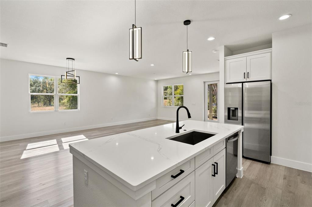 2956 West Higgins Place Dunnellon, FL 34433 - Photo 16 of 52 a kitchen with stainless steel appliances granite countertop a sink a stove and a refrigerator