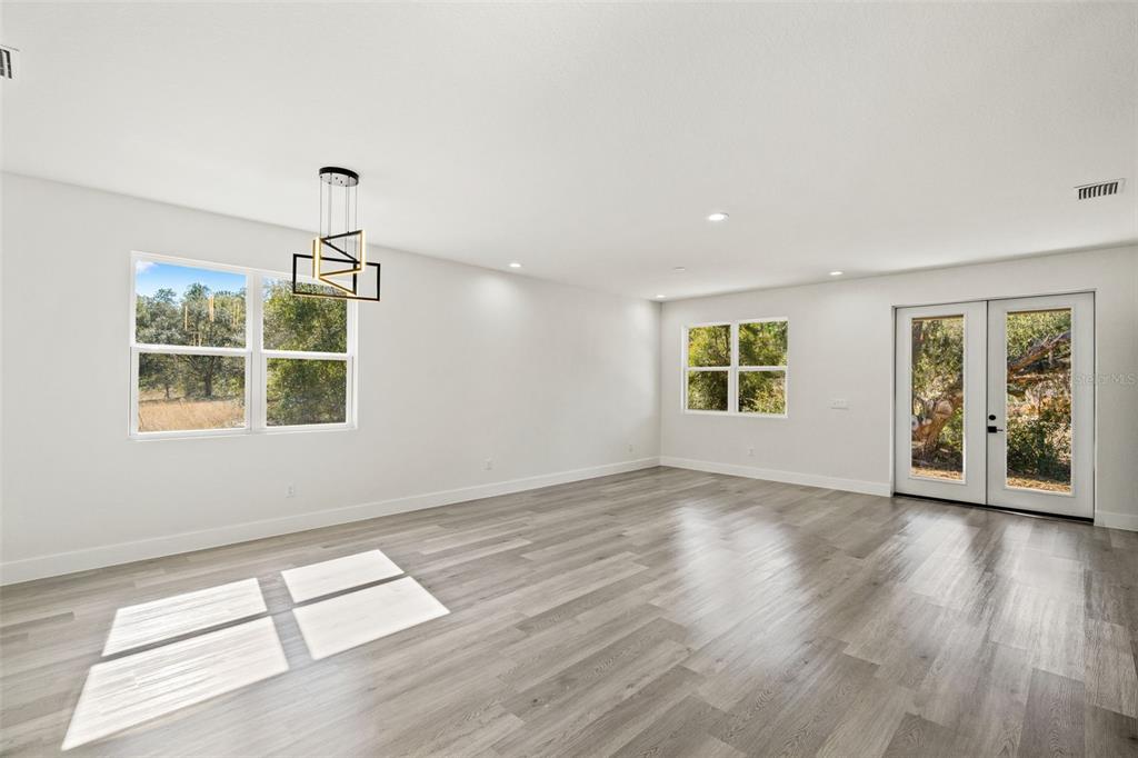 2956 West Higgins Place Dunnellon, FL 34433 - Photo 19 of 52 a view of an empty room with wooden floor and a window