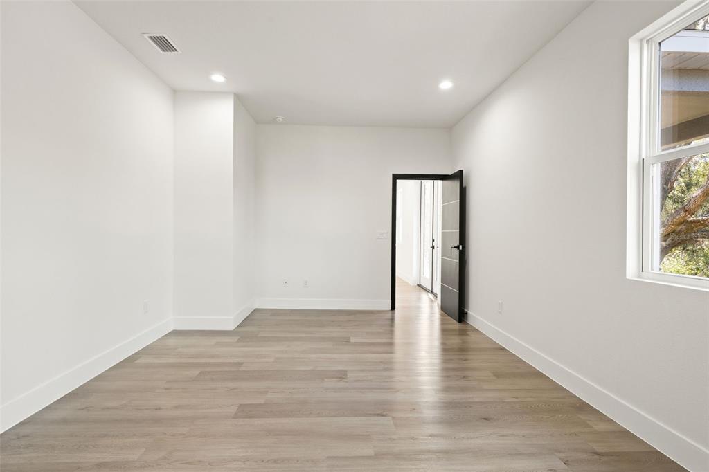 2956 West Higgins Place Dunnellon, FL 34433 - Photo 30 of 52 a view of an empty room with wooden floor and a window