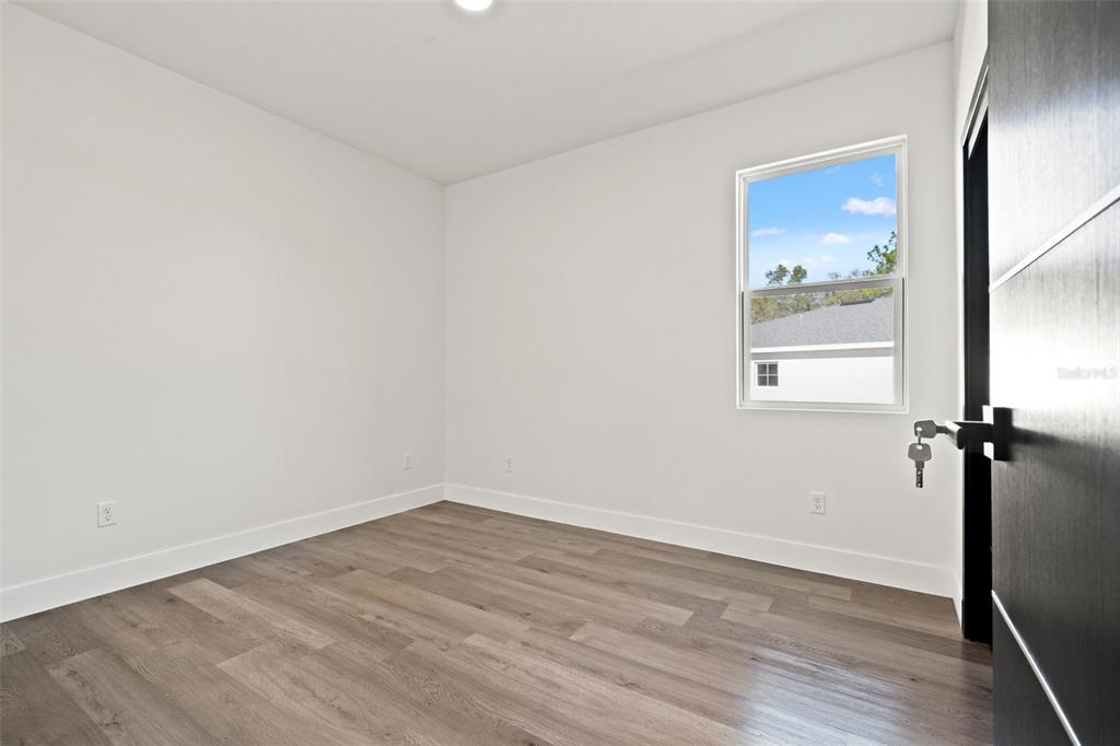 2956 West Higgins Place Dunnellon, FL 34433 - Photo 33 of 52 a view of an empty room with wooden floor and a window