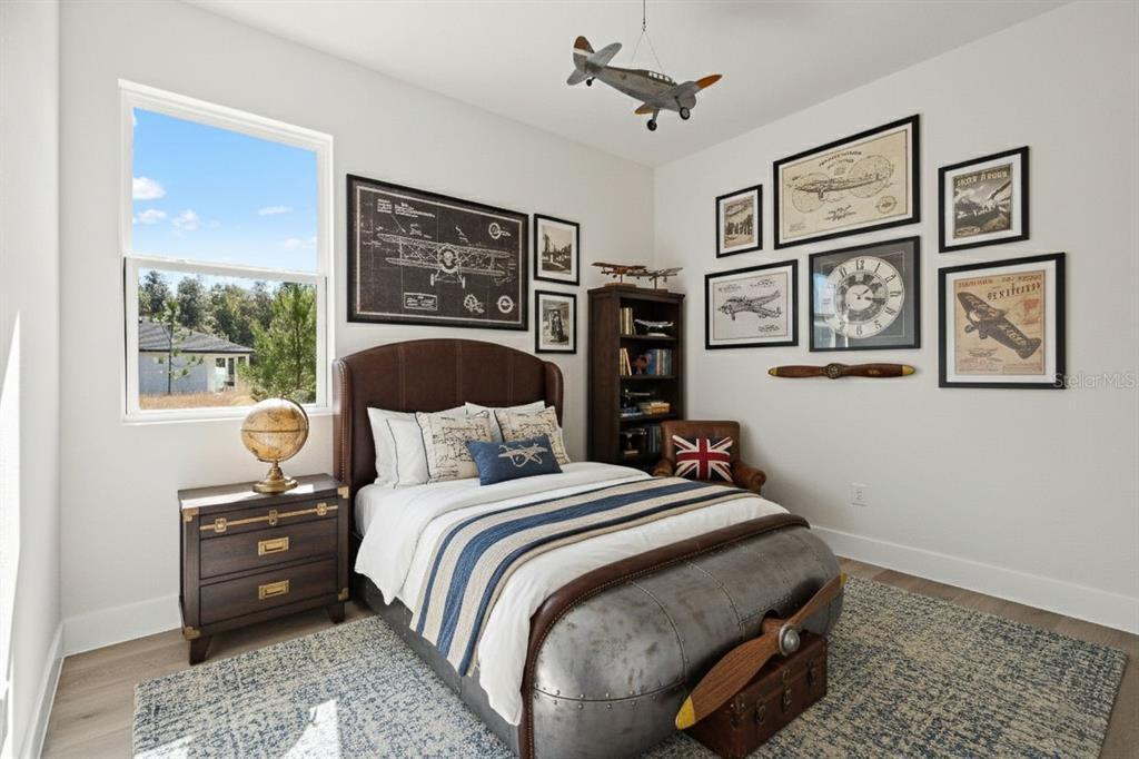 2956 West Higgins Place Dunnellon, FL 34433 - Photo 41 of 52 a bedroom with a bed a wall painting and a window