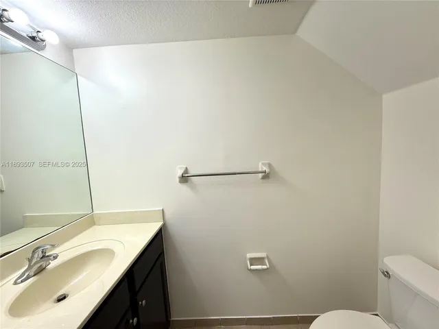 a bathroom with a vanity and a mirror