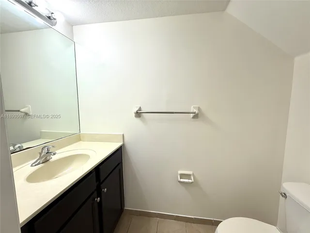 an empty room with a window and a ceiling fan