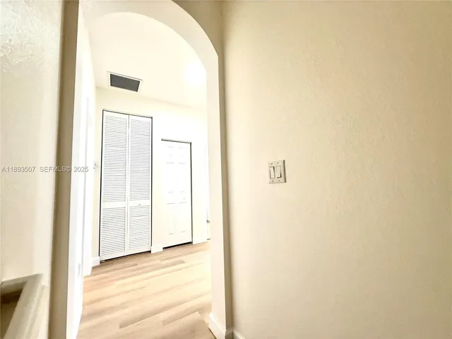 a view of a livingroom with a ceiling fan and wooden floor