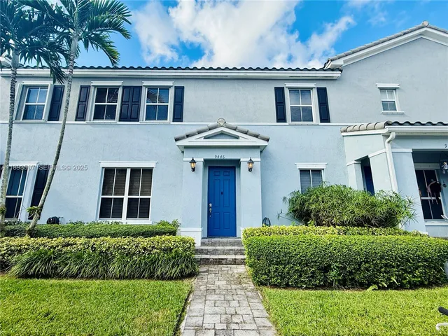 a house with a small yard and potted plants