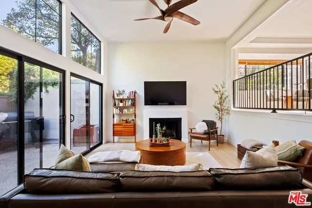a living room with fireplace furniture and a flat screen tv