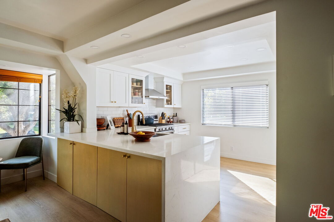 207 South Oakland Avenue, Unit A Pasadena, CA 91101 - Photo 14 of 41 a kitchen with stainless steel appliances a sink a stove and a window