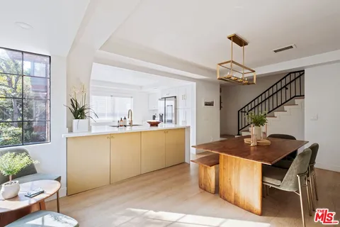 a kitchen with a table and chairs