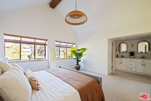 a bedroom with a bed dresser and a window