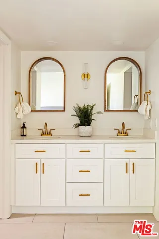 a bathroom with sink mirror and vanity