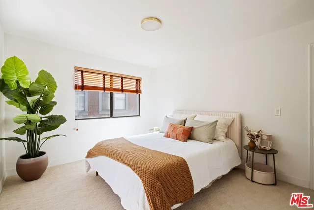 a bedroom with bed and window