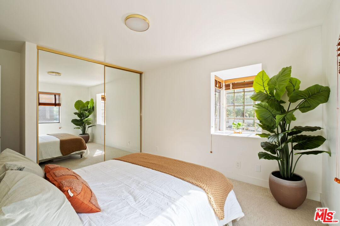 207 South Oakland Avenue, Unit A Pasadena, CA 91101 - Photo 29 of 41 a bedroom with bed and a potted plant