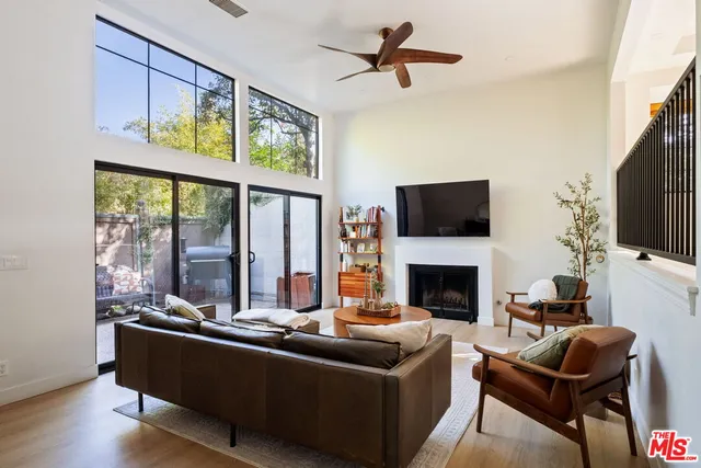 a living room with furniture fireplace and flat screen tv