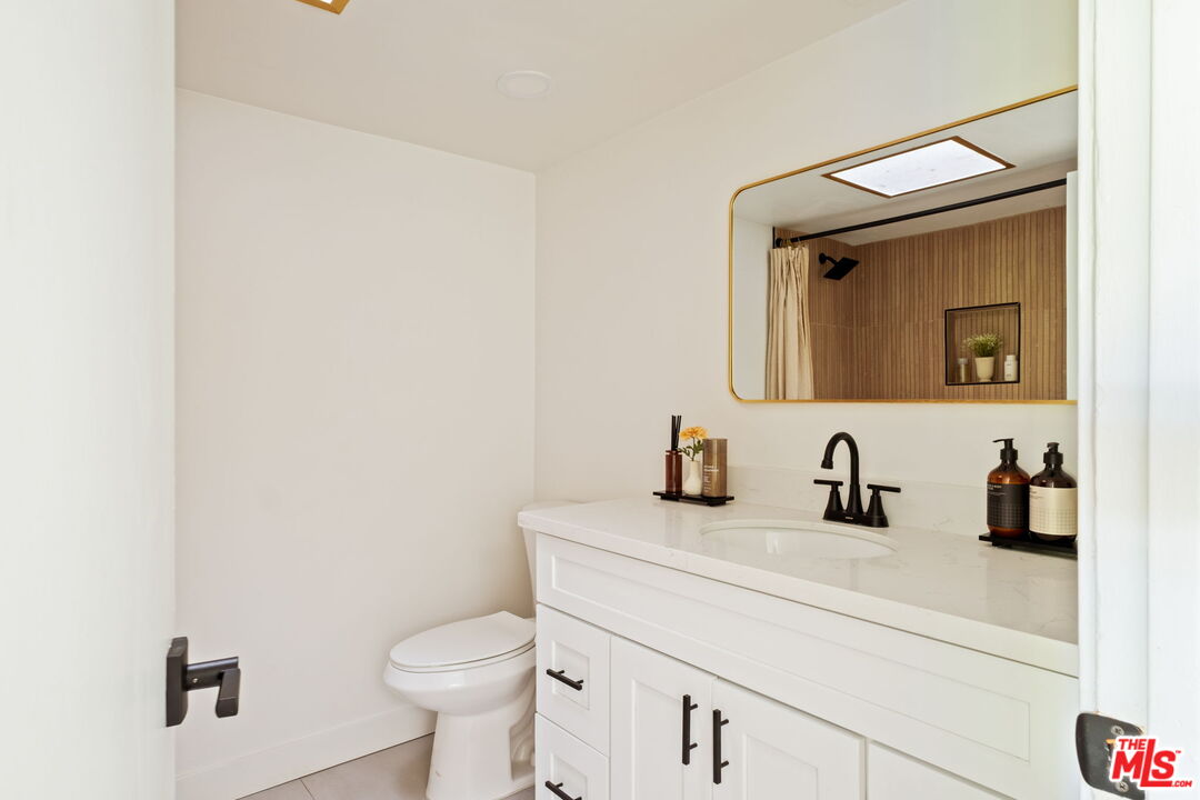 207 South Oakland Avenue, Unit A Pasadena, CA 91101 - Photo 32 of 41 a bathroom with a toilet sink and mirror