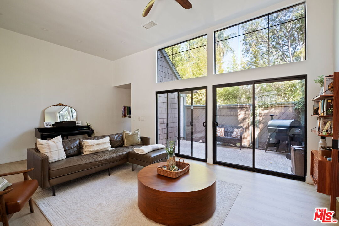 207 South Oakland Avenue, Unit A Pasadena, CA 91101 - Photo 5 of 41 a living room with furniture and a floor to ceiling window