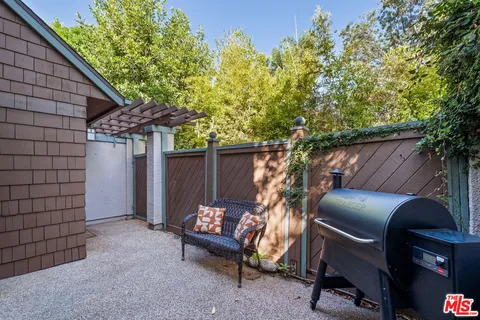 a view of backyard with outdoor seating and trees