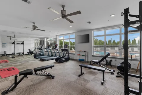 a view of a livingroom with workspace and a window