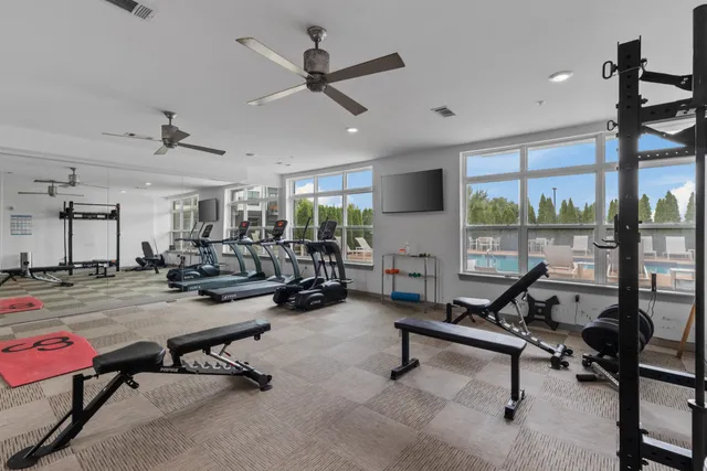 a view of a livingroom with workspace and a window