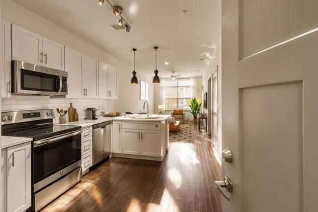 a kitchen with a sink a stove and cabinets