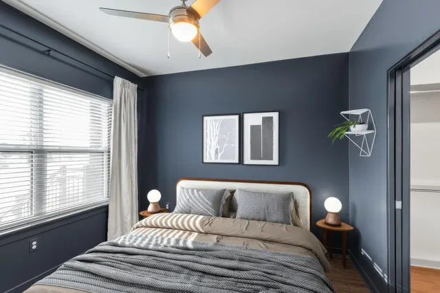 a bedroom with a bed and a window