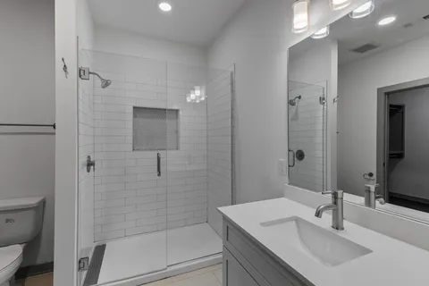 a bathroom with a sink toilet and shower