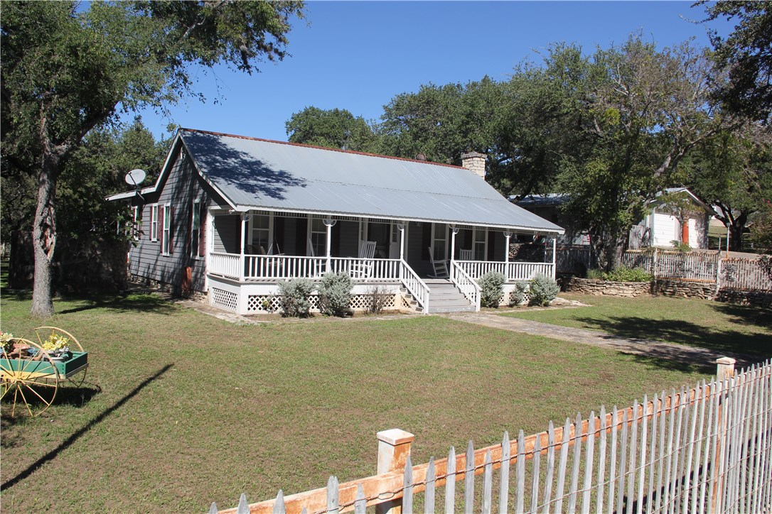 5420 Fall Creek Road Spicewood, TX 78669 - Photo 1 of 1 a front view of a house with garden
