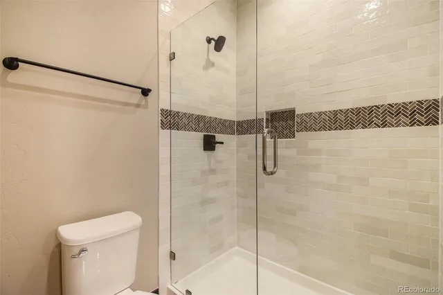 a bathroom with a shower and toilet