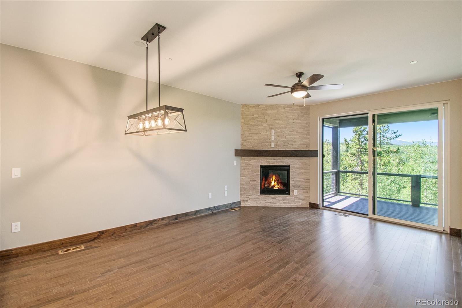 69 High Grove Loop Winter Park, CO 80482 - Photo 20 of 21 a view of an empty room with wooden floor fireplace and a window