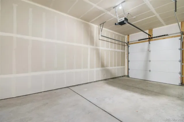 an empty room with a window and a ceiling fan