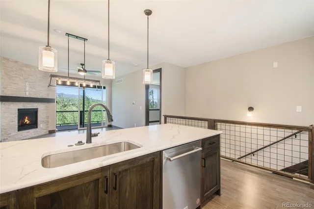 a kitchen with a sink and a wooden floor