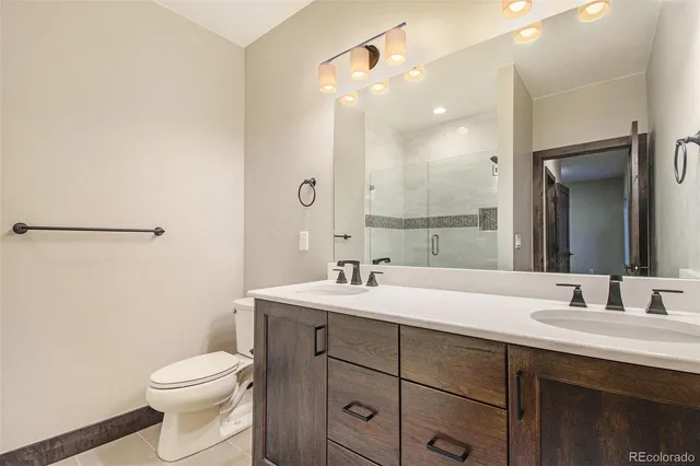 a bathroom with a sink toilet and mirror
