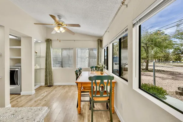 a view of a house with backyard and sitting area