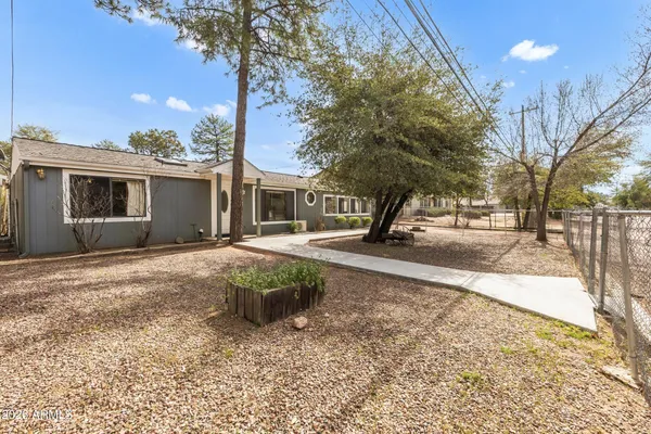 a front view of a house with a yard covered with snow