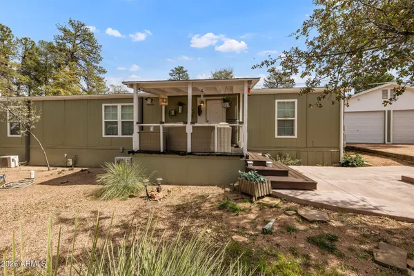 a view of a house with a patio and a yard