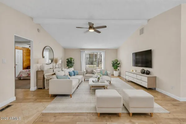a living room with furniture and a flat screen tv