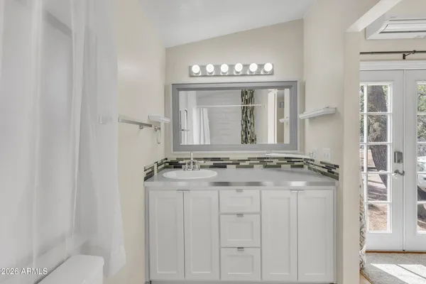 a bedroom with a bed table and window