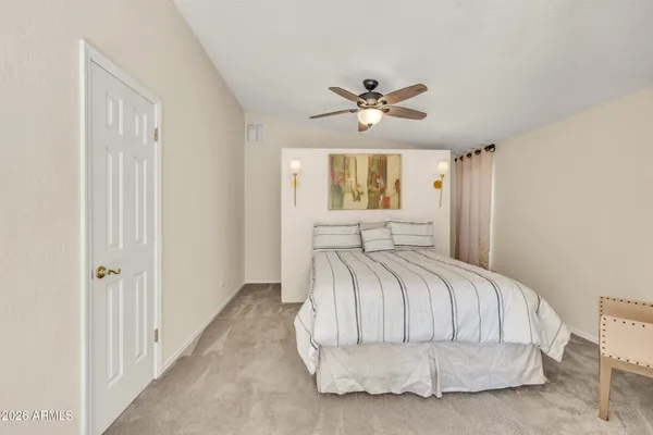 a bathroom with a sink vanity mirror and toilet