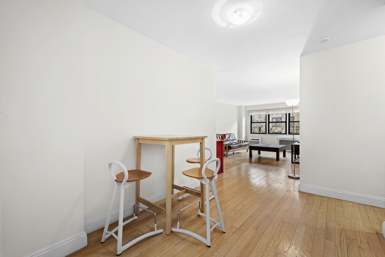 579 West 215th Street, Unit 5A Manhattan, NY 10034 - Photo 5 of 7 a living room with furniture and a wooden floor