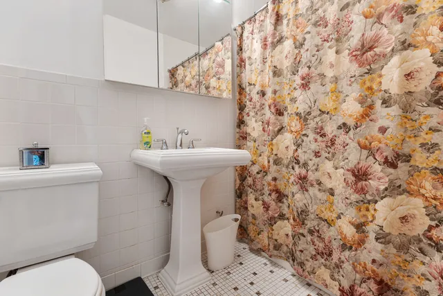 a bathroom with a sink toilet and a mirror