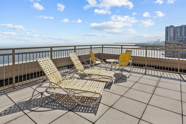 a terrace with outdoor seating and city view