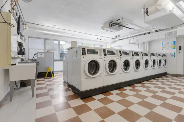 a utility room with stainless steel appliances and cabinets