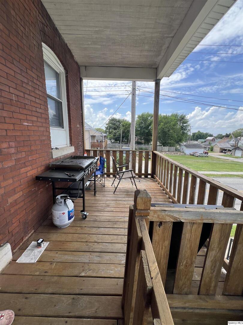 801 Monroe Street Quincy, IL 62301 - Photo 16 of 34 a view of a balcony with chairs and wooden floor