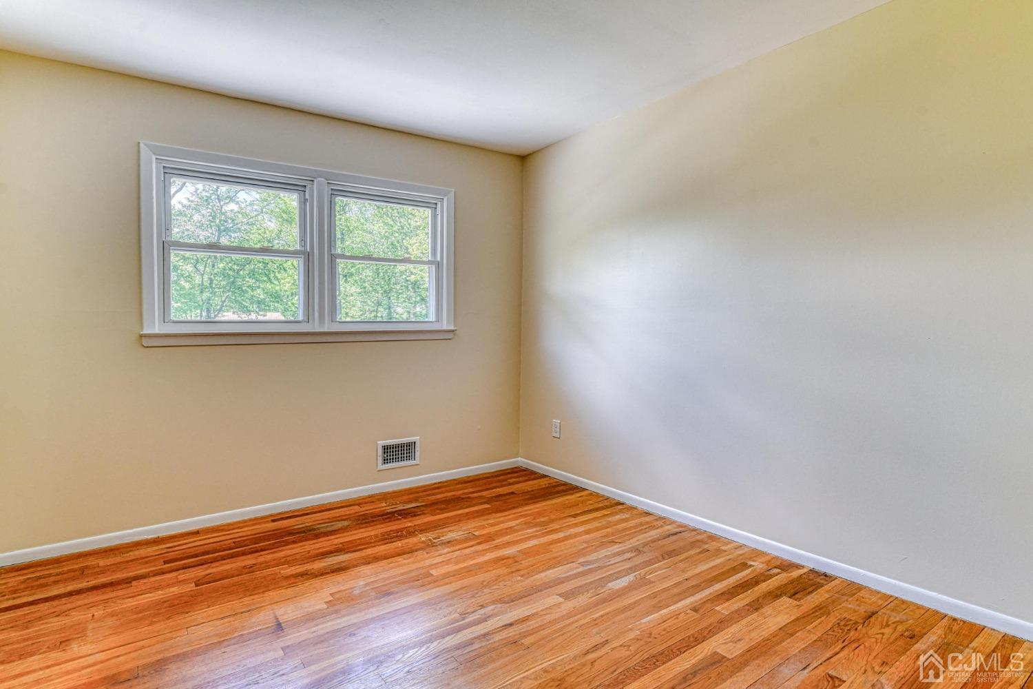 630 Dewey Road North Brunswick, NJ 08902 - Photo 8 of 28 a view of empty room with wooden floor and fan