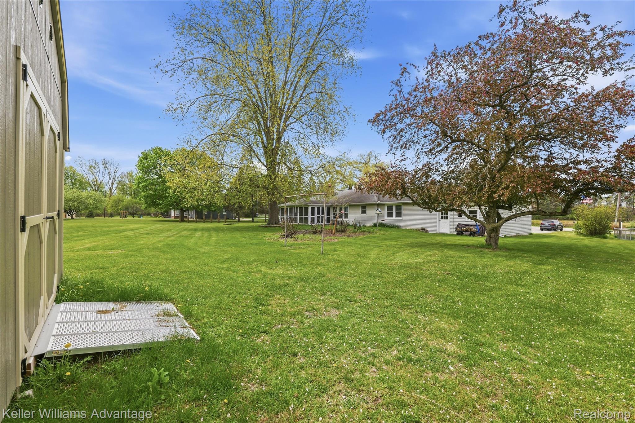 6595 Bray Road Vassar, MI 48768 - Photo 47 of 64 View of green lawn featuring a sunroom