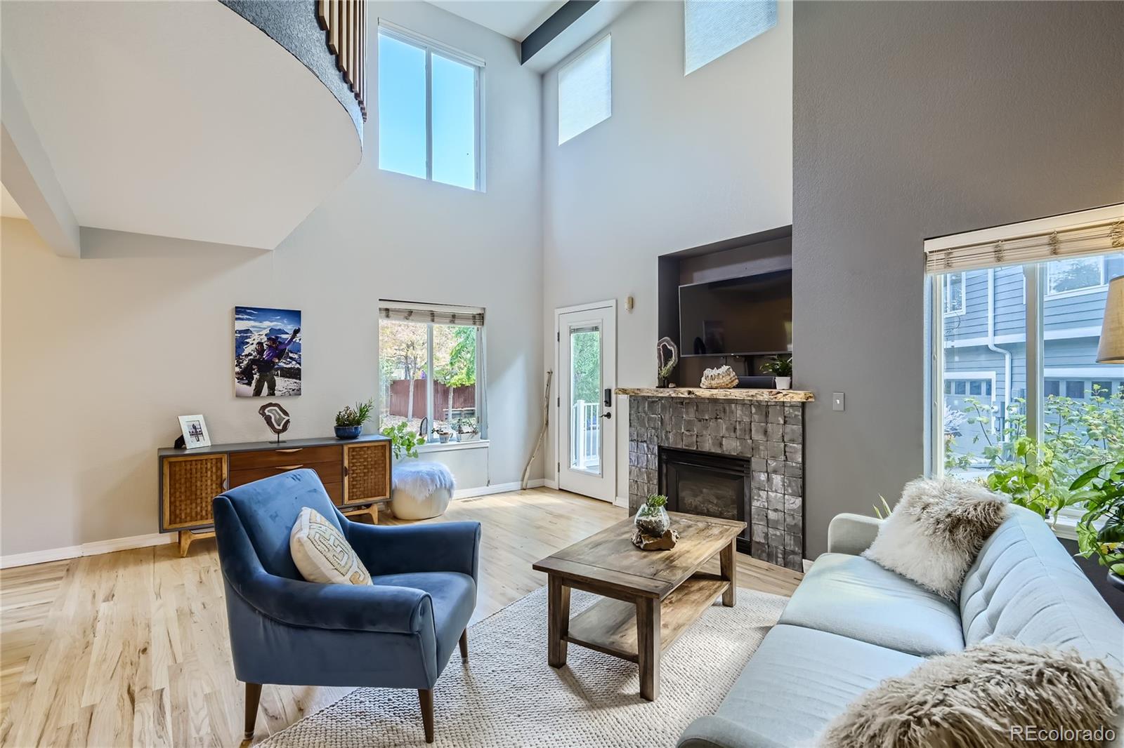 4766 Franklin Drive Boulder, CO 80301 - Photo 3 of 26 a living room with furniture a flat screen tv and a fireplace