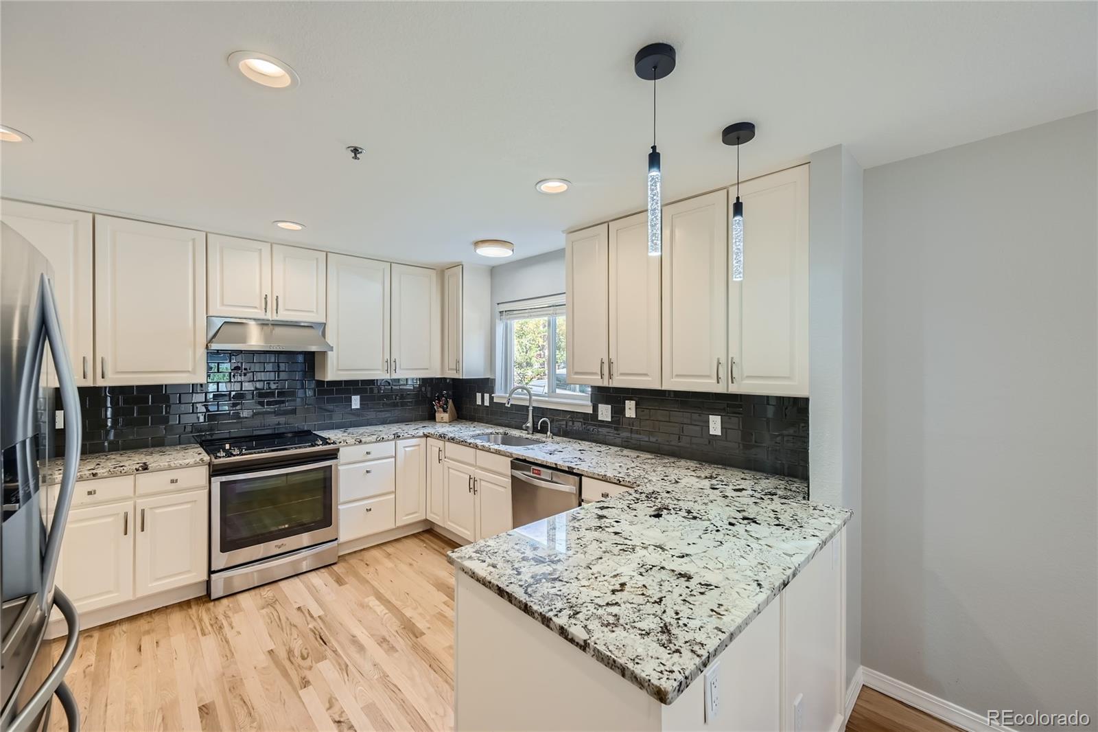 4766 Franklin Drive Boulder, CO 80301 - Photo 6 of 26 a kitchen with stainless steel appliances granite countertop a sink stove and refrigerator