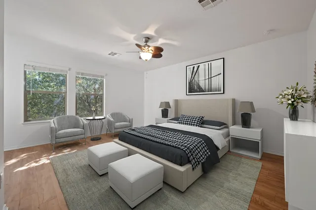 a bedroom with a large bed couch and a window